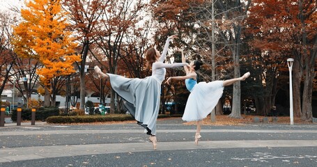 Ballet, dancing and women in autumn on the street in Japan park with pointe shoes and creative...