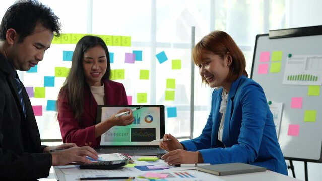 Young Asian Creative Business Conference Group Work as a team to discuss project initiation strategies, analyze financial processes. Plan and brainstorm online marketing ideas with your office laptop.