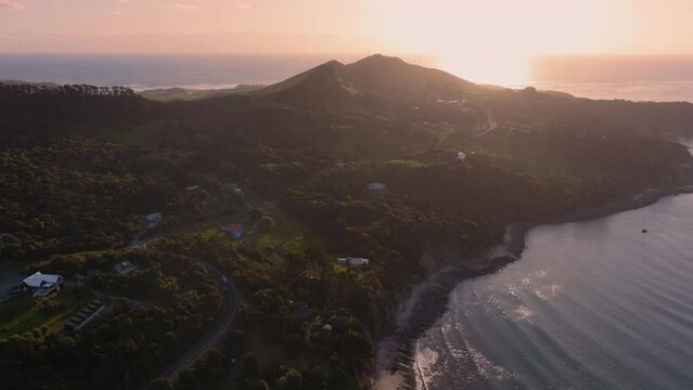 Aerial: The towns of Omapere and Opononi in the the Hokianga Harbour at sunset, Northland, New Zealand.