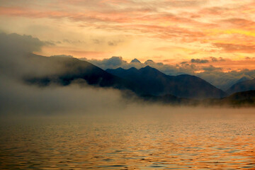 Atmospheric morning fog over Lake Yazevoe in eastern Kazakhstan. Lake Yazevoe is located at an altitude of 1685 meters above sea level. It is part of the State National Natural Park 