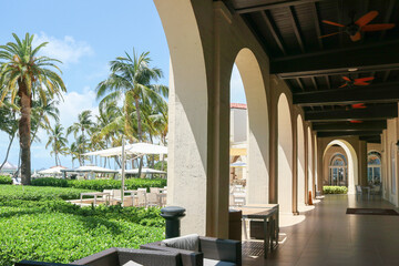 Tropical Elegance: Red Ceiling Fans, Palm Trees, and Wicker Seating at Key West's Luxury Resort