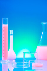 Blue gradient background with laboratory concept for advertising product. Test tube, erlenmeyer...