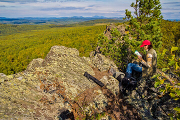 Obraz premium beautiful mature woman travels through the mountains of the Southern Urals