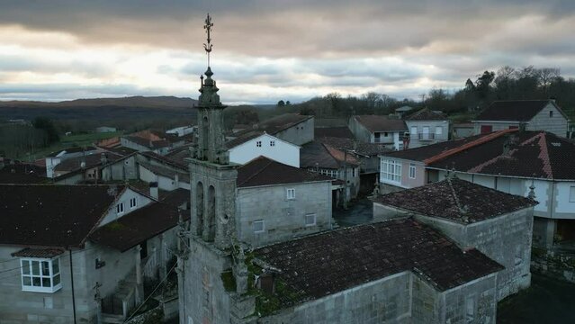 Aerial orbit around old broken down church with epic bell tower and lightning rod