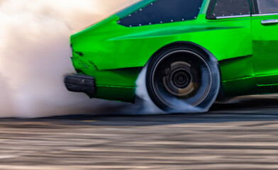 Blurred car drifting diffusion race drift car with lots of smoke from burning tires on speed track, Professional driver drifting car on race track with smoke. © Darunrat