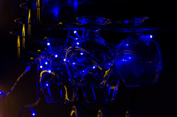 glasses for brandy or cognac, in the bar in a beautiful blue festive light.