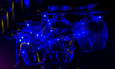 glasses for brandy or cognac, in the bar in a beautiful blue festive light.