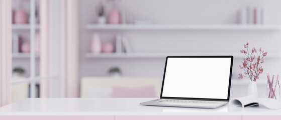 A white-screen laptop computer mockup on a white-pink desk in a modern, girlie pink room.
