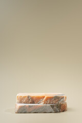 Pieces of granite stone on beige background for display