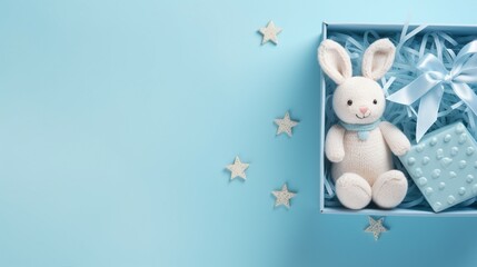 Fototapeta premium Capturing Precious Moments: Top View of Soft Baby Clothing and Accessories in a Giftbox
