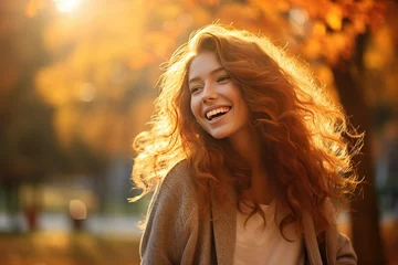 Poster Realistic portrait of a young happy smiling woman in an autumn park, captured with the essence of golden-hour sunlight © LaxmiOwl