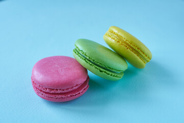 Colorful macaroons on blue background. Sweet macaroon.