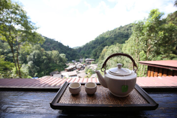 Herbal tea with two white tea cups and teapot in ban mae kampong village on the mountain in...