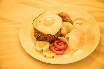 Ceplok egg fried rice with added vegetables, fried chicken and crackers