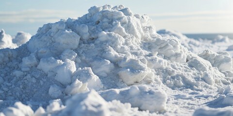 A pile of snow sitting on top of a beach. Suitable for winter beach scenes or contrasting elements in nature