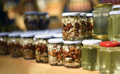Many jars of honey with nuts