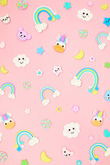 Trendy pastel pink kawaii background with cute air plasticine handmade cartoon animals, unicorns, stars, rainbows pattern. Top view, flat lay. Candycore, fairycore.