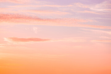 A beautiful sky tinted by the sun leaving vibrant shades of gold, pink, blue and multicolored. Clouds in the twilight evening and morning sky. Cloudy sky background in the evening and during the day.