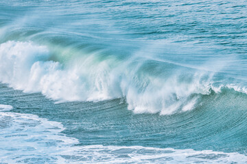 Wave splashing close-up. Crystal clear sea water, in the ocean in San Francisco Bay, blue water, pastel colors.