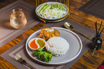 Thai street food, traditinal Thai omlete stuff minced pork for lunch time on wooden table background