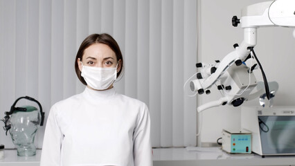 Portrait of a female dentist looking at the camera in the interior of a modern dental clinic in the workplace. The concept of the dentist profession and healthy teeth.