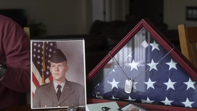 Senior man looking at a scrapbook after retiring from military service
