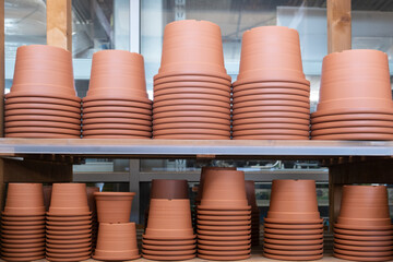 Empty garden Plastic Pots in a row on the metal shelf in the hardware store. Spring Gardening concept