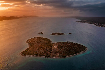 Galesnjak, Croatia - Aerial panoramic view of the beautiful heart-shaped island Galesnjak with a colorful warm summer sunset above the Adriatic mediterranean sea