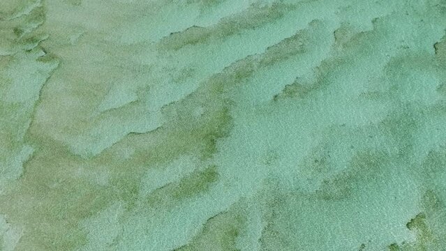 Transparent ocean water with sandy sea floor. Surigao del Sur, Philippines.