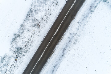 drone aerial view of a road in a snowy landscape
