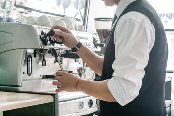 barista making coffee in the cafe