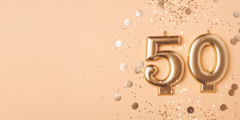 50 years celebration. Greeting banner. Gold candles in the form of number forty on peach background...