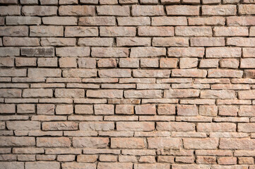 An old brick wall textured and pattern. A brick is a type of block used to build walls.