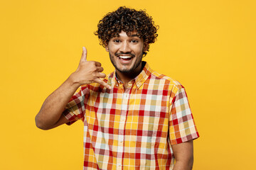 Young smiling happy fun Indian man he wears shirt casual clothes doing phone gesture like says call...