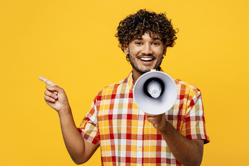 Young Indian man he wears shirt casual clothes hold in hand megaphone scream announces discounts...