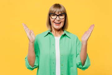 Elderly surprised shocked excited fun blonde woman 50s years old wear green shirt glasses casual...