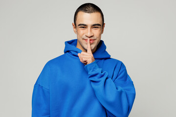 Young secret fun middle eastern man he wear blue hoody casual clothes say hush be quiet with finger...