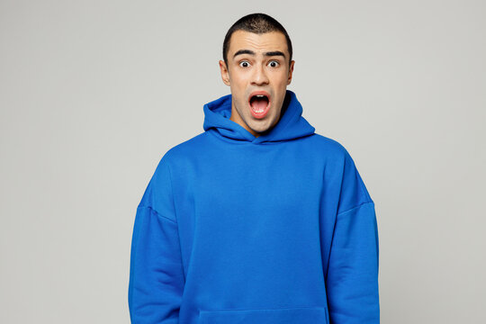 Young sad shocked astonished amazed middle eastern man he wearing blue hoody casual clothes look camera scream shout scream isolated on plain solid white background studio portrait. Lifestyle concept.