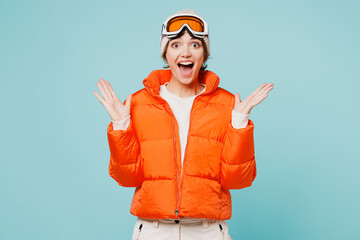 Skier young surprised amazed woman she wearing warm padded windbreaker jacket hat ski goggles mask...