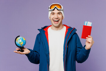 Traveler man wear blue windbreaker jacket ski goggles mask hat hold passport ticket globe isolated...