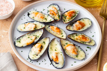 Baked mussels with cheese and herbs. Seafood. Healthy eating.