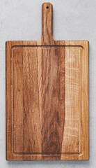 Chopping board. Wooden cutting board on gray concrete stone background. Top view, copy space.