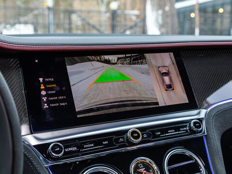 Novosibirsk, Russia - January  05 , 2024:  white Bentley Continental GT , reverse camera with monitor,buttons - details and controls of modern car.