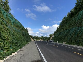 Breathtaking coastal highway along vibrant green cliffs. Scenic coastal route.