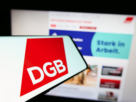 Stuttgart, Germany - 12-29-2023: Cellphone with logo of German organization Deutscher Gewerkschaftsbund (DGB) in front of website. Focus on left of phone display.