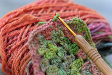 Closeup detail of crochet work with a colourful skein of organic natural handspun and handdyed...