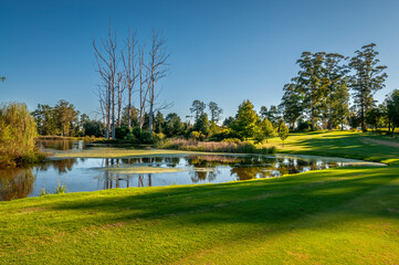 Golf course with treelined fairways and mountain views
