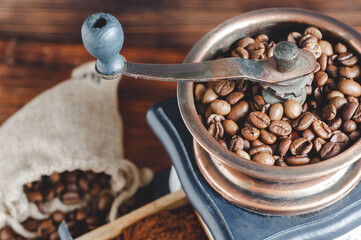 Vintage coffee grinder, coffee beans on wooden background