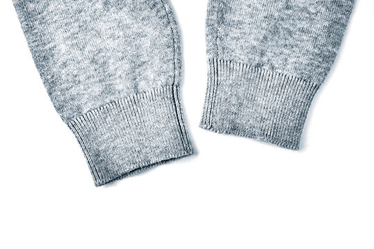 Knitted warm fabric. Wool texture close-up as a background. Gray cashmere.