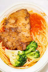 angle view chicken cutlet with tomato and meat sauce pasta at vertical composition